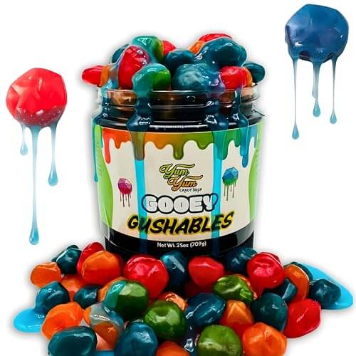 Gooey Gushables Sour in a jar with colorful candy pieces spilling out, showcasing liquid candy sauce.