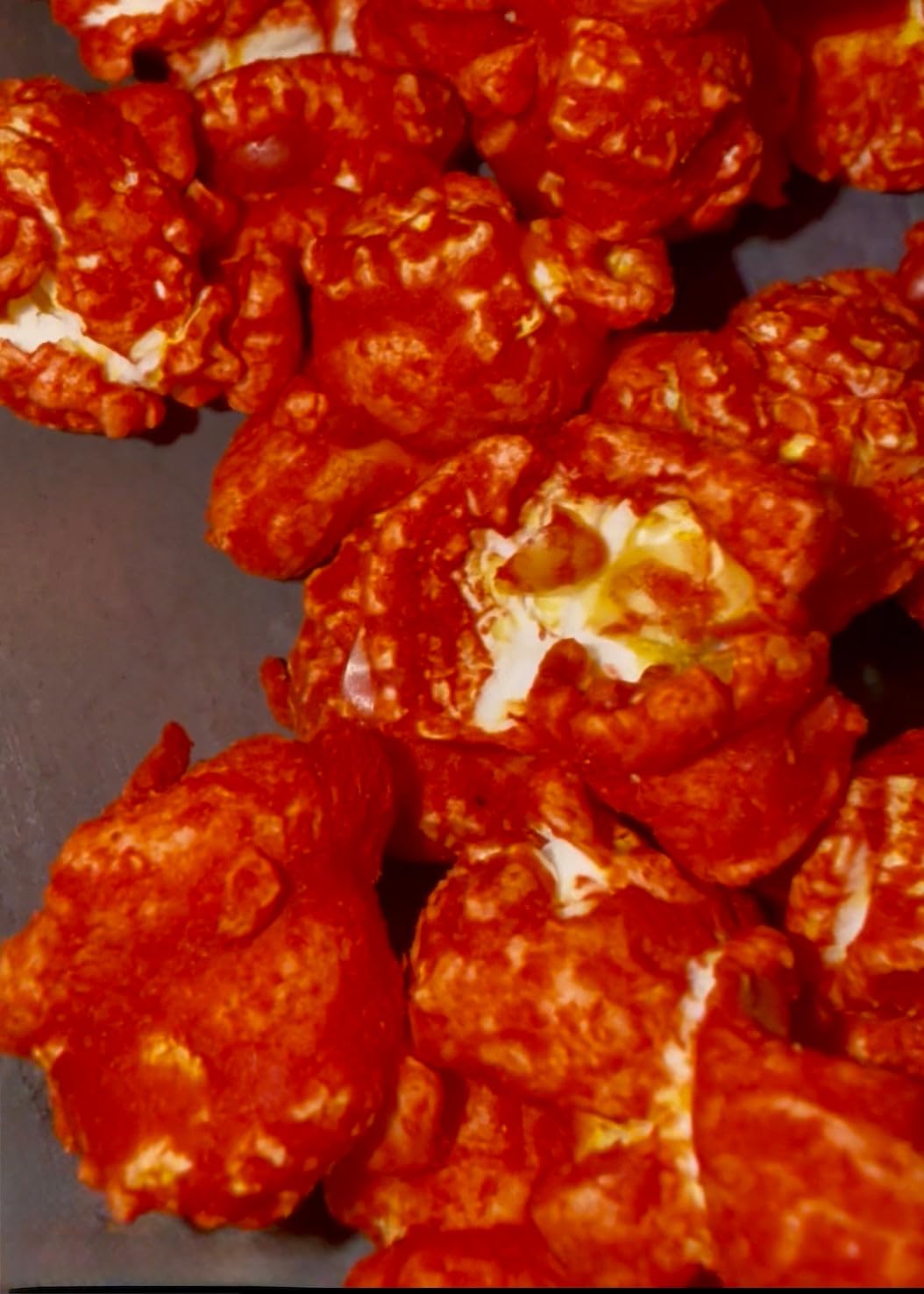 Hot Junior Snacks Co. Hot Cheddar popcorn with bold cheesy flavor and spicy seasoning.