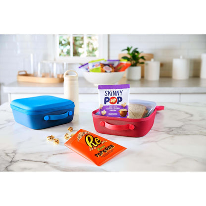 SkinnyPop Family Favorite Variety Pack displayed with colorful lunch containers on a kitchen table.