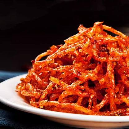 Chinese Spicy Latiao Gluten Strips served on a white plate, showcasing their vibrant red color and spicy texture.