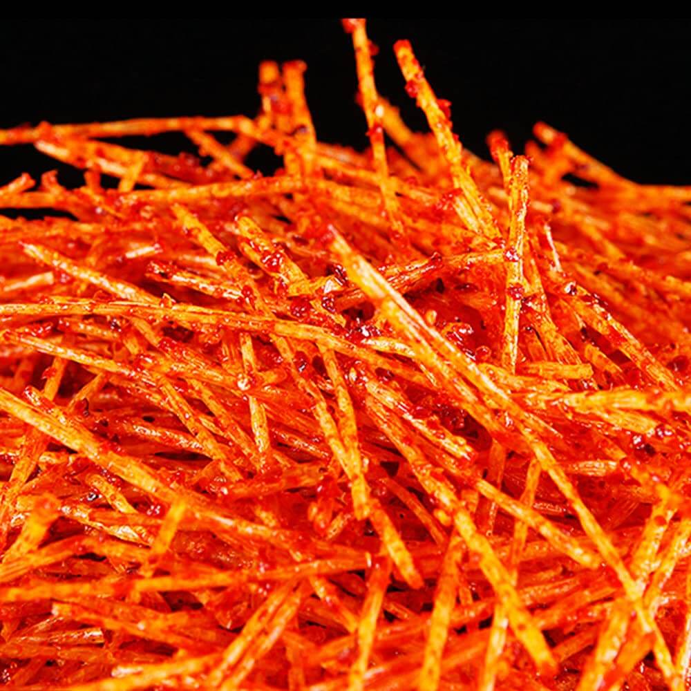 Chinese Spicy Latiao Gluten Strips piled high, showcasing their vibrant red color and spicy coating.