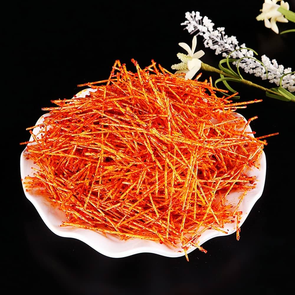 Chinese Spicy Latiao Gluten Strips piled on a white plate, showcasing the vibrant colors and texture of this spicy snack.