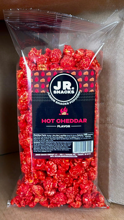 Hot Junior Snacks Co. Hot Cheddar bag filled with spicy cheddar popcorn for snack lovers.