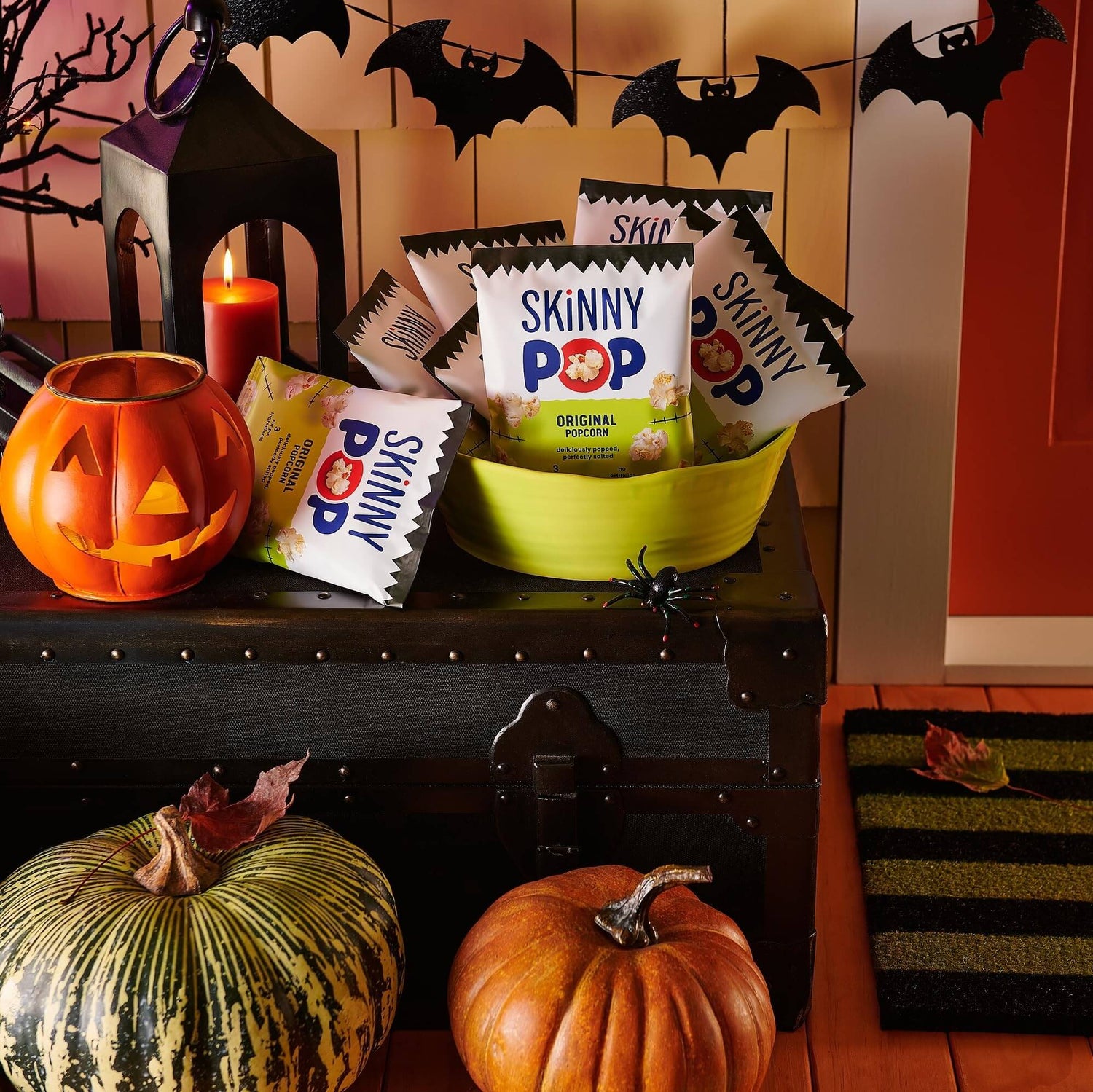 SkinnyPop Family Favorite Variety Pack in a festive bowl for Halloween snacks with pumpkins and bats.